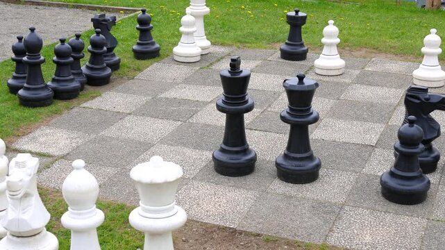 Giant outdoor chess game with big pieces in a park