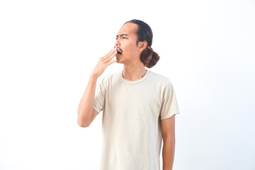 Fototapeta premium Young Asian man in a shirt, with a bored and tired expression. Isolated on a white background