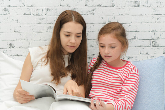 Mom and daughter reading together