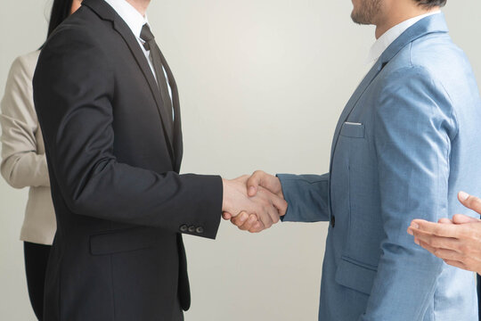 Business corporate agreement concept, Two group of business doing partner contract agreement together shaking hands to confirm deal.
