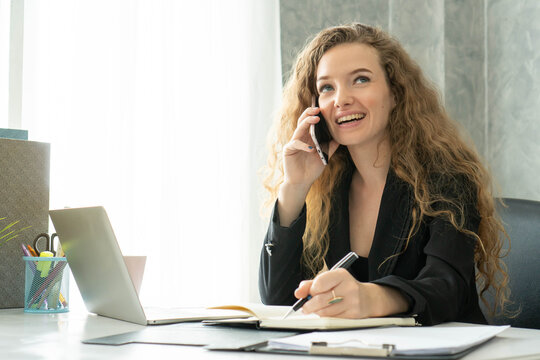 Attractive executive business woman talking on phone smile communication in workplace office
