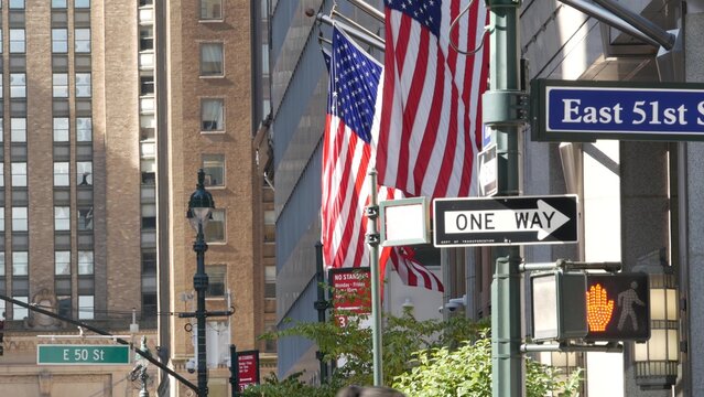 New York City Park Avenue, street sign in Manhattan Midtown, United States. Urban road sign, traffic sign in NYC, USA. Building architecture near Grand Central. One way arrow and American flag