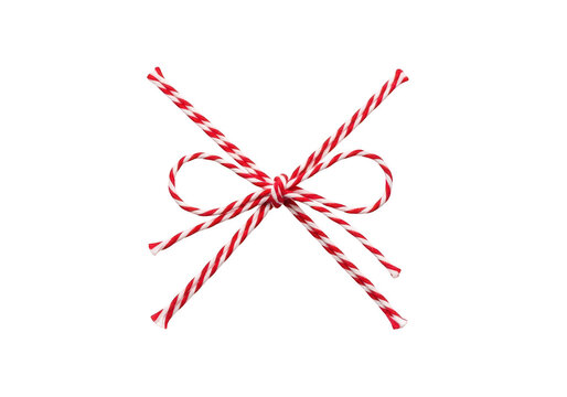 Decorative red and white striped twine tied in a neat bow knot for gift wrapping and festive holiday craft projects on a clean dark background isolated on a transparent background