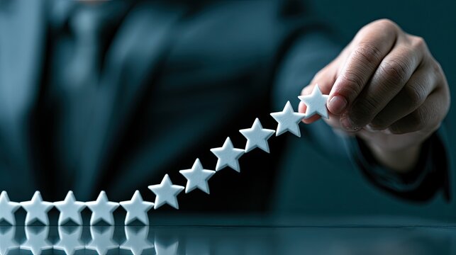 Hand arranging white stars in a row, forming a line for rating
