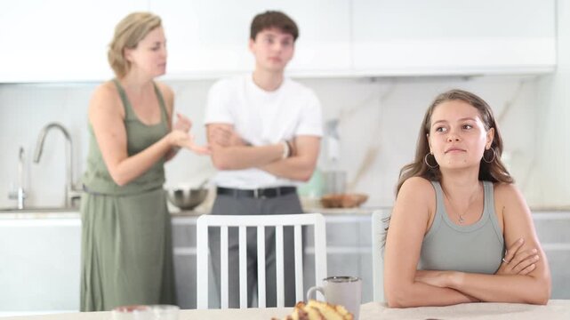 Woman and young guy swear at girl. Mom and older brother scold young girl for unsuccessful studies at university. Complex intergenerational relationships