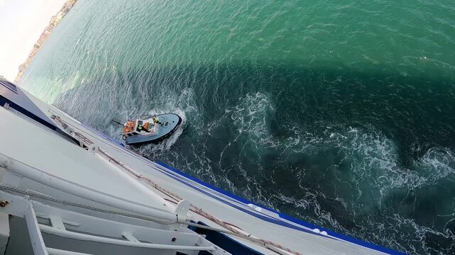 Pilot boat moving away from the ship after collecting the pilot at Santander,Spain.