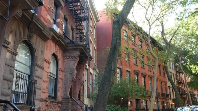 New York City urban residential buildings architecture, Manhattan classic street, Greenwich village, United States of America. Typical red brick house in NYC, real estate property in USA. West village