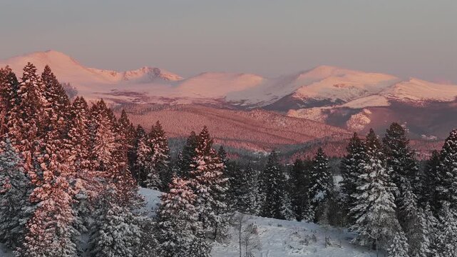 First light sunrise Purple Rocky Mountains Majesty Mount Blue Sky Evergreen Colorado aerial drone springtime fresh snow vibrant alpenglow early morning Mt Evans wilderness landscape circle parallax