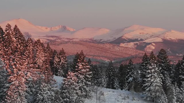 First light sunrise purple Rocky Mountains majesty Mount Blue Sky Evergreen Colorado aerial drone springtime snow vibrant alpenglow early morning Mt Evans wilderness landscape right parallax zoom