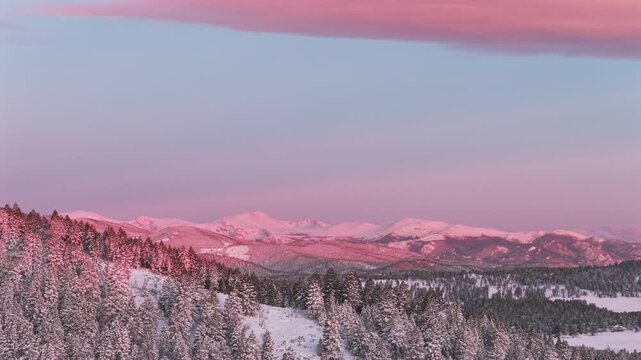First light sunrise purple Rocky Mountains majesty Mount Blue Sky Evergreen Colorado aerial drone springtime fresh snow vibrant alpenglow early morning Mt Evans wilderness landscape landmark left