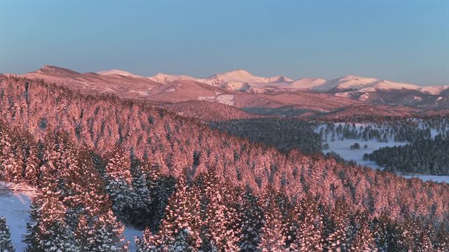 Alpenglow vibrant morning sunrise majestic purple Front Range Rocky Mountains Mount Blue Sky Evergreen Colorado aerial drone spring Conifer Mountain snow Mt Evans wilderness landscape landmark pan