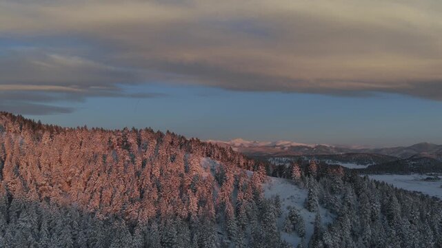 Majestic purple Front Range Rocky Mountains Mount Blue Sky Evergreen Colorado aerial drone spring vibrant morning sunrise alpenglow Evergreen Meadows Mt Evans wilderness landscape landmark forward