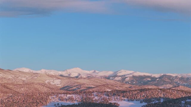 Majestic purple Front Range Rocky Mountains Mount Blue Sky Evergreen Colorado aerial drone springtime morning sunrise alpenglow snow Evergreen Meadows Mt Evans wilderness landscape landmark right