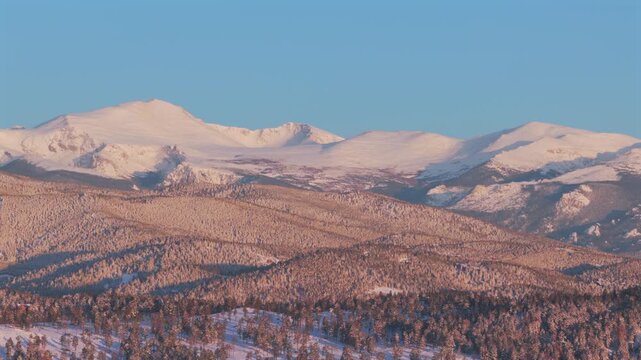 Majestic purple Front Range Rocky Mountains Mount Blue Sky Evergreen Colorado aerial drone springtime morning sunrise alpenglow snow Evergreen Meadows Mt Evans wilderness landscape landmark static