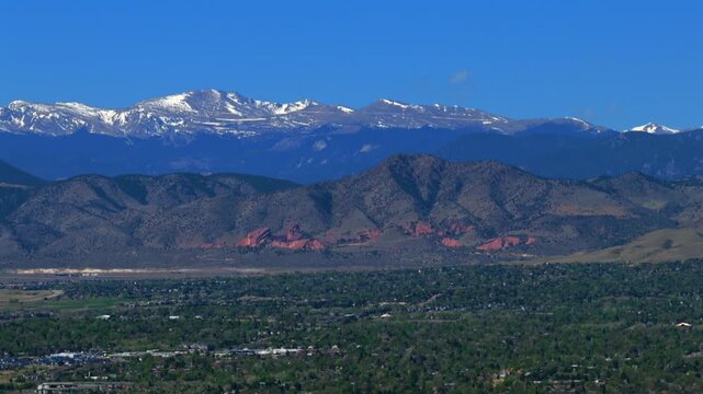 Denver Colorado foothills Front Range Rocky Mountains aerial drone spring season snow-capped Mt Blue Sky Red Rocks Park and Amphitheater landmark Morrison Lakewood Littleton landscape circle right