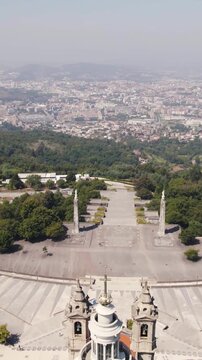 Vertical aerial pullback of the Sanctuary of Sameiro with Braga cityscape in Portugal.