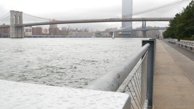 Brooklyn Bridge, Manhattan Bridge from Brooklyn Bridge park, New York City Dumbo, United States. American architecture, famous tourist landmark. Waterfront promenade, riverside esplanade perspective