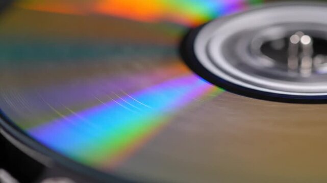 Macro shot of a compact disc showing colorful rainbow light reflections