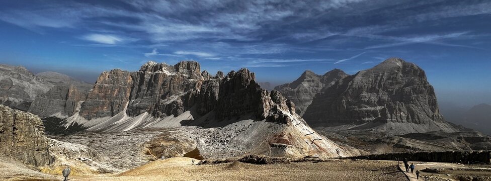 Beautiful panoramic view of Seceda mountain sharp ridges and green slopes with pine forest under sunny blue sky, landmark of Val Gardena, Dolomites, Italy.