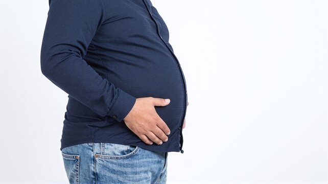 Fat man holding belly in studio