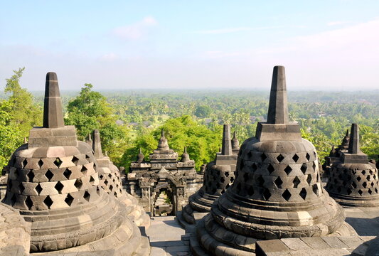 Borobudur Temple &ndash; Stone stupas and temple architecture at the historic Buddhist monument in Central Java, Indonesia, overlooking the surrounding tropical landscape.
