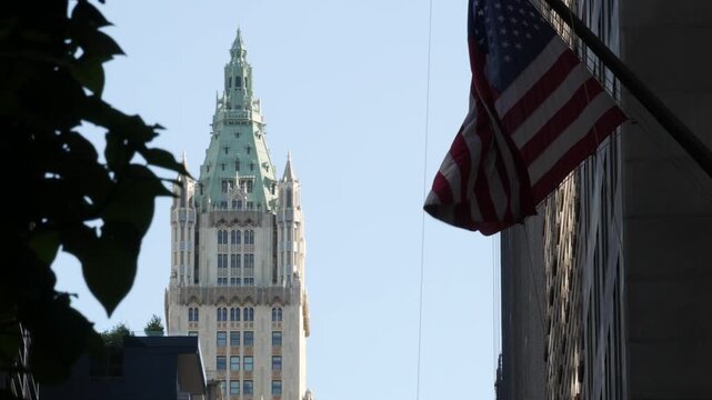 New York City Woolworth building 1913, skyscraper on Broadway in Downtown Financial District, Lower Manhattan, United States of America. Gothic historic architecture, cooper roof, USA american flag