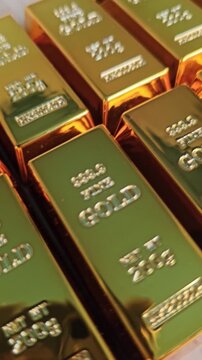 Gold bars stacked in a neat arrangement showing their weight and purity in clear detail
