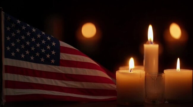 American flags and burning candles glowing in dark background for memorial day remembrance tribute