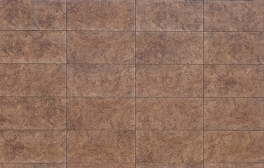 Fototapeta premium Brown porcelain stoneware tiles for flooring or wall coating with stone and earthenware effect. Full frame, background and texture.