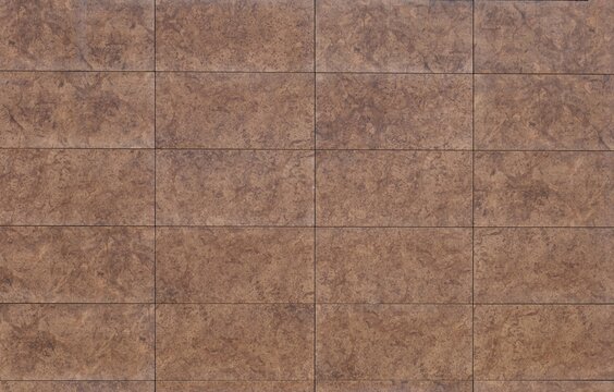 Brown porcelain stoneware tiles for flooring or wall coating with stone and earthenware effect. Full frame, background and texture.