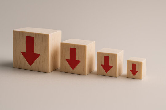Wooden blocks with red arrows decreasing in size convey business decline concept. negative trend showing crisis, failure, and recession on neutral background with soft lighting