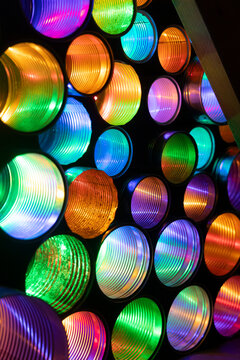 A beautiful close up of colorful LED lights in empty tin cans. An art installation outdoors in Geiranger during Light Art Festival in winter, UNESCO World heritage area.