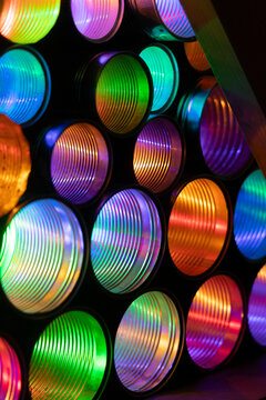 A beautiful close up of colorful LED lights in empty tin cans. An art installation outdoors in Geiranger during Light Art Festival in winter, UNESCO World heritage area.