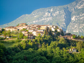 Obraz premium View of the village of Voltino. In the background are Monte Baldo and an indigo-colored sky. Voltino is part of the municipality of Tremosine.