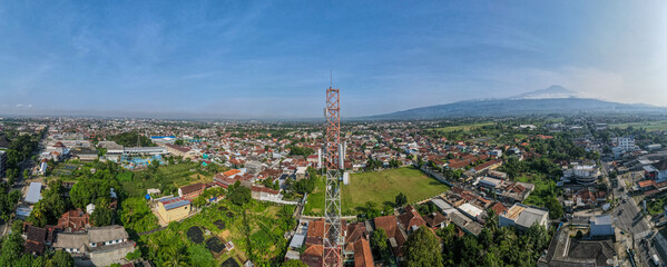 Aerial Panorama View of Cellular Telecommunications Tower Near Football Field in Urban Area © katakaneh