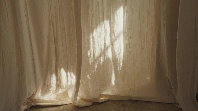 Morning sunlight streaming through a window onto curtains