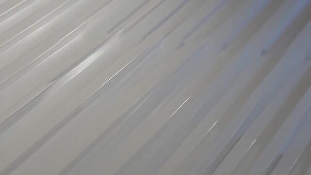 A close up view of white parallel ridges creating a clean abstract geometric pattern