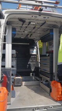 Rear view of white commercial work van loaded for job, vertical view