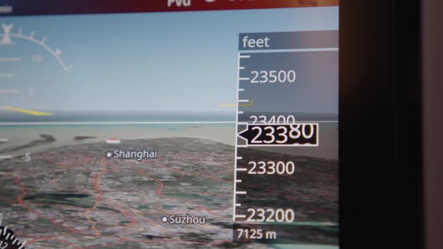 Close-up of an aircraft's navigation screen displaying altitude and map over Shanghai and Suzhou. Useful for aviation and travel content.