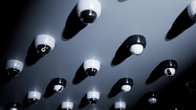 A dense array of surveillance cameras continuously loops the footage.