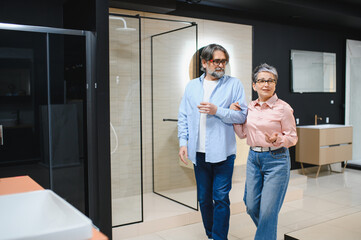 Fototapeta premium Senior couple choosing bathroom shower cabin and vanity