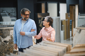 Obraz premium Senior couple choosing tiles for home renovation project