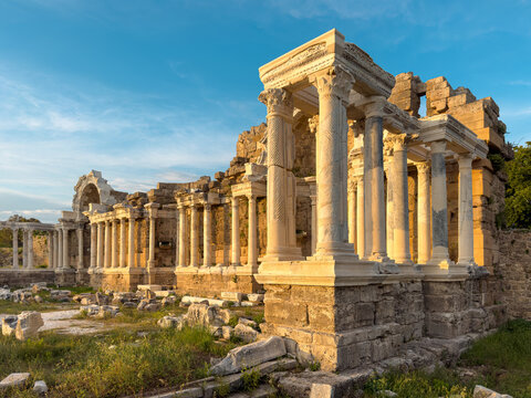 Monumental fountain ruins at Side Ancient City under dramatic blue sky in Antalya, Turkey