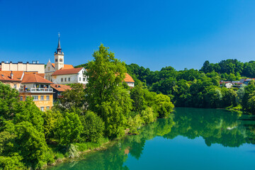 Obraz premium Skyline of town of Novo Mesto, mirrored in Krka river, Slovenia