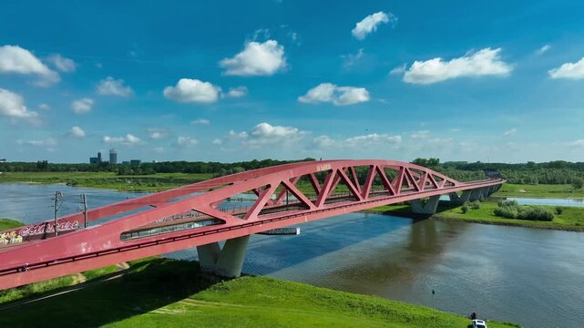 Aerial footage of the Hanzeboog (Hanseatic Arch), a combined railway and cycle bridge spanning the IJssel river. The bridge was opened in June 2011