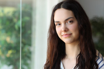 Fototapeta premium Portrait of a beautiful teenage girl posing looking at camera