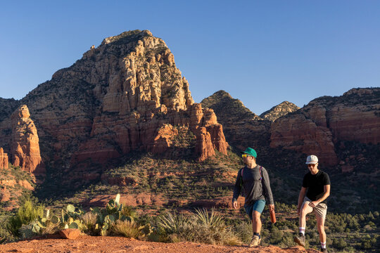 Two male friends hiking a rugged desert trail
