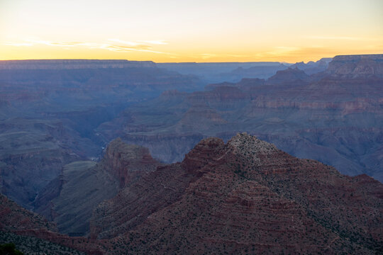 Golden sunset light over vastness of Grand Canyon
