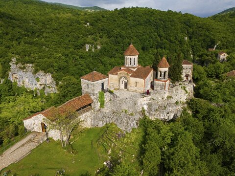 Historic monastery on steep hills surrounded by lush greenery, aerial view, Motsameta Monastery, near Kutaisi, Imereti region, Georgia
