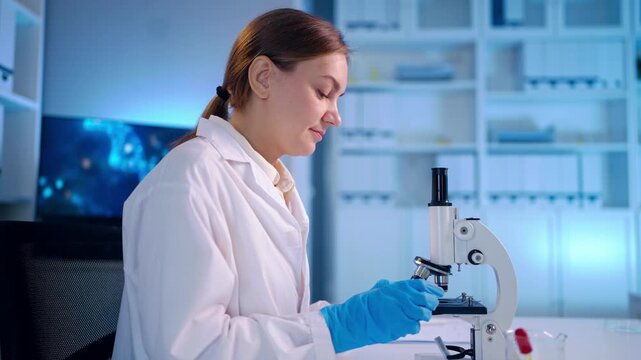 Caucasian female scientist in white lab coat working in the laboratory.